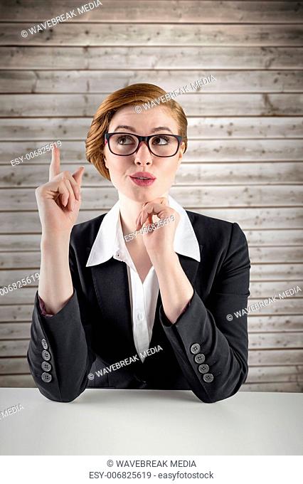 Composite image of thinking redhead businesswoman
