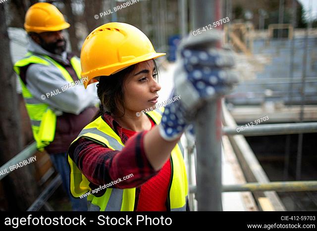 Thoughtful female construction worker at construction site