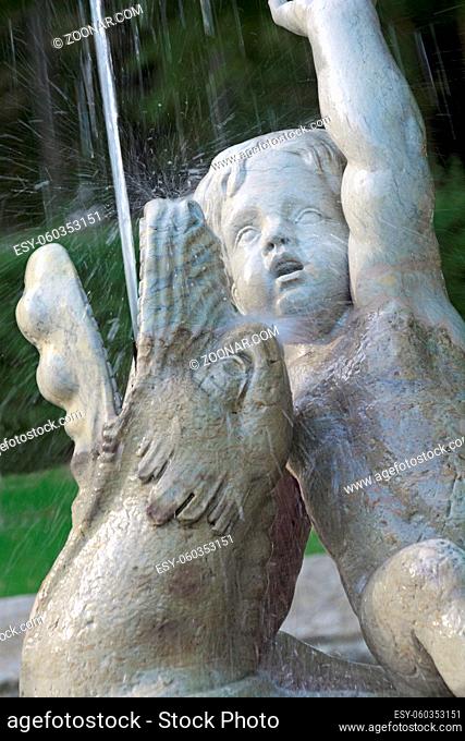 Fountain with figures and water jet in portrait format