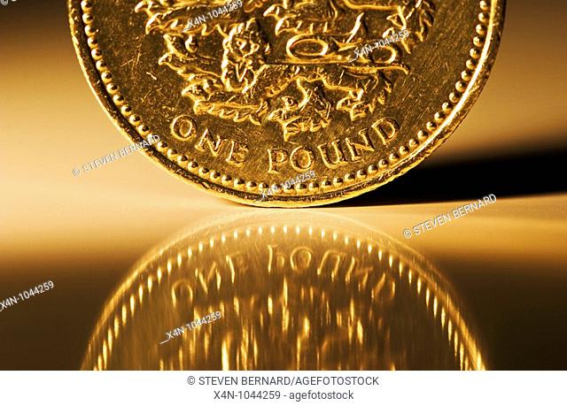Macro shot of British pound coin on reflective surface