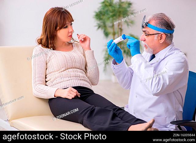 Young woman visiting male doctor otorhinolaryngologist