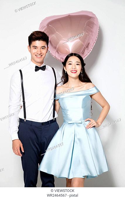 Young couple with heart-shaped balloon