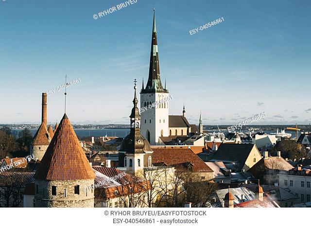 Tallinn, Estonia. Part Of Tallinn City Wall With Towers, At The Top Of Photo There Is Tower Of Church Of St. Olaf Or Olav. Popular Destination Scenic
