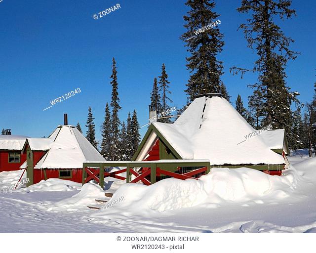 snowcovered wooden huts in lapland