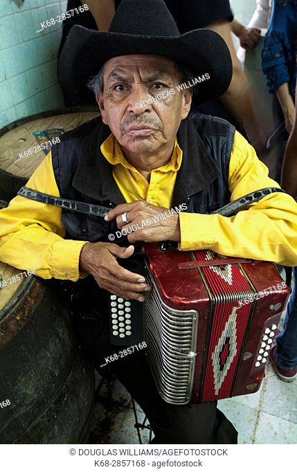 A man with an accordion in a pulqueria in Xochimilco, Mexico City, Mexico