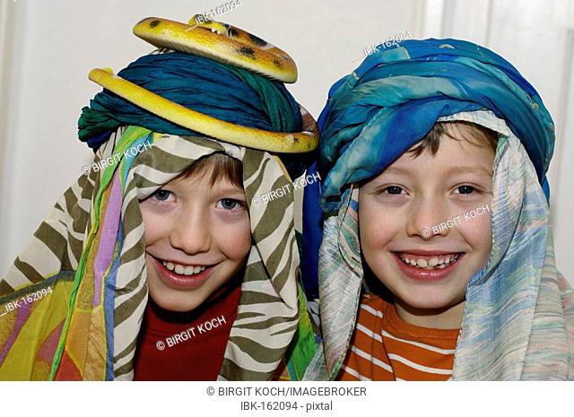 Eight and ten-year-old children masquerading as sheik and snake charmer