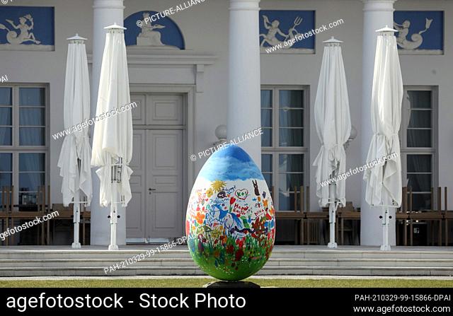 25 March 2021, Mecklenburg-Western Pomerania, Heiligendamm: A large Easter egg stands in front of the spa house of the Grand Hotel