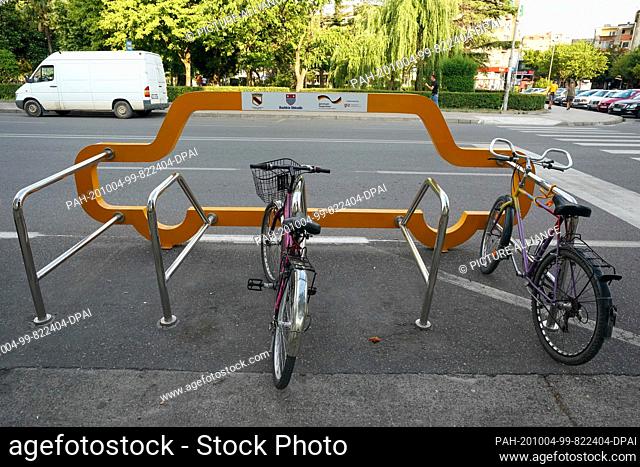 21 June 2020, Albania, Shkodra: A bicycle rack space the size of a car in Shkoder. The bicycle stand is a project of the ""Deutsche Gesellschaft für...
