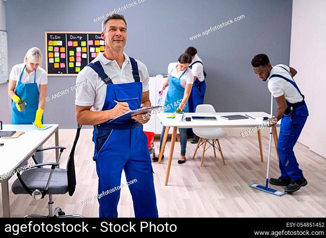 Janitor With His Team Cleaning Modern Office