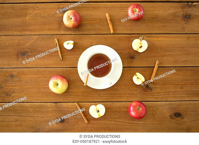sliced apples and knife on wooden cutting board
