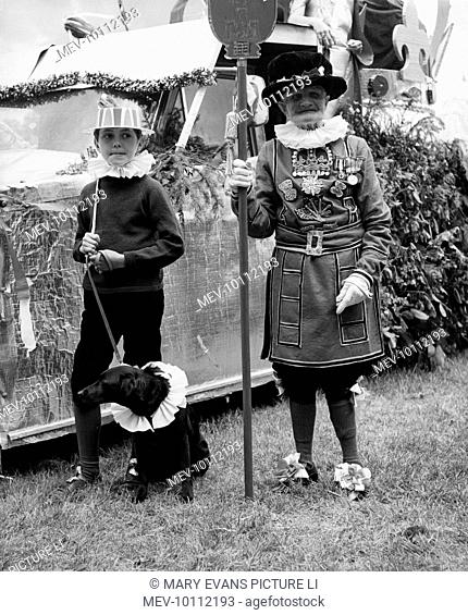 ELIZABETH II'S SILVER JUBILEE Fancy dress with an Elizabethan theme at a fete in Leigh, Surrey. The old man is dressed as a Beefeater
