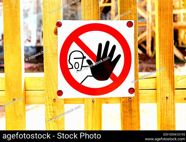 Stop hand sign danger on the wooden fence