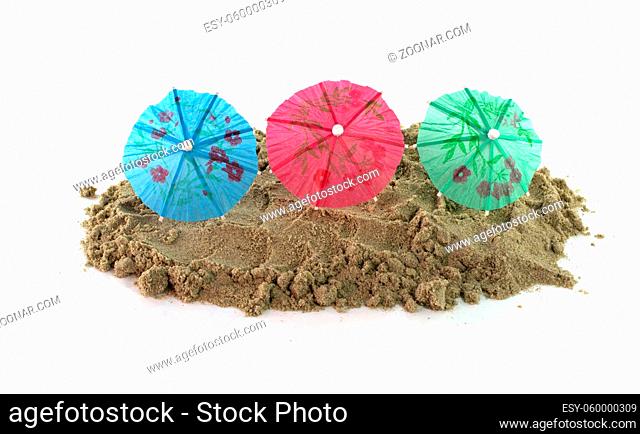 green blue red cocktail Umbrellas in Sand Mound