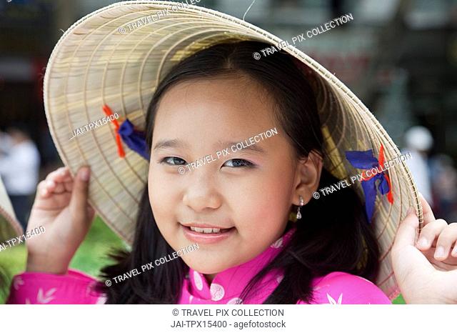 Vietnam, Ho Chi Minh City, Girl Dressed in Traditional Vietnamese Costume