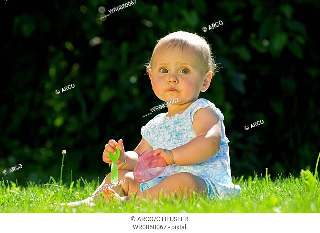Baby with plastic tableware