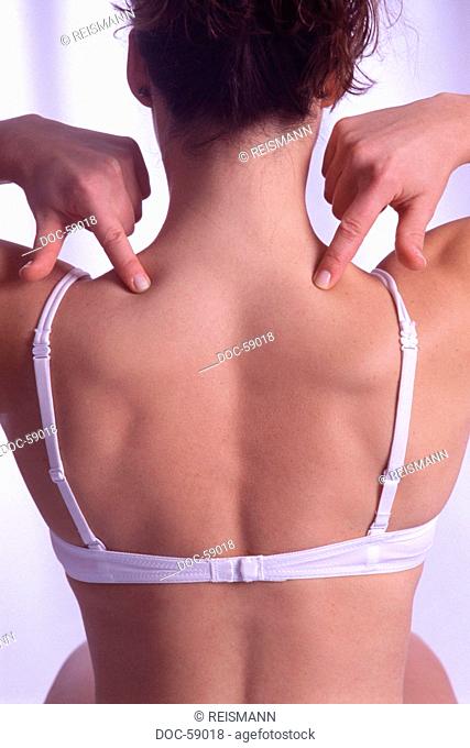 woman massaging acupressure point fei-yan against cervical vertebra columns pains