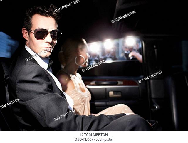 Paparazzi taking pictures of celebrities in limo