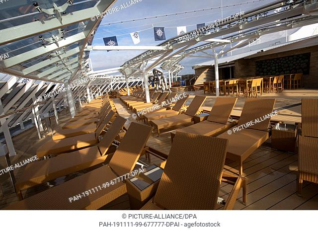 09 November 2019, Hamburg: Sun loungers are standing on the sun deck of the MSC Yacht Club on board the cruise ship MSC Grandiosa during a press tour