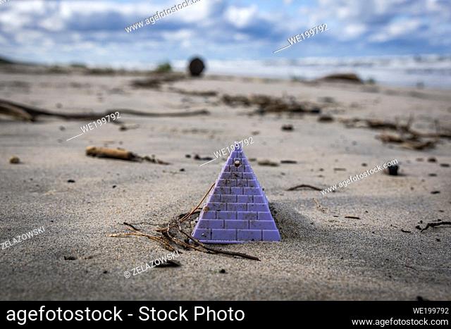 Plastic toy thrown by the sea on a beach of Vistula Spit between Katy Rybackie and Skowronki villages, Bay of Gdansk in the Baltic Sea, Poland