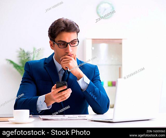 The businessman employee talking on the office phone