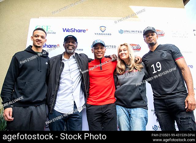01 May 2021, US, Lake Forest: Football player Amon-Ra St. Brown (M) stands between his family after being selected in the NFL draft. Brother Osiris St