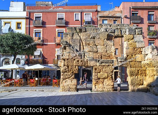 Roman ruins facades of houses buildings and restaurants in Plaça del Forum Square in the old city center of Tarragona. Tarragona old town and city center...