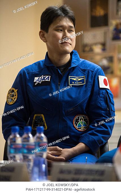 Expedition 54 flight engineer Norishige Kanai of Japan Aerospace Exploration Agency (JAXA) is seen in quarantine, behind glass, during a press conference