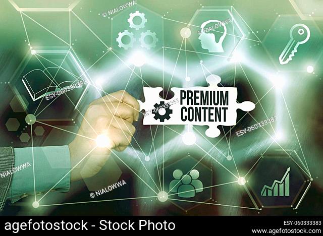 Conceptual caption Premium Content, Internet Concept higher quality or more desirable than free content Hand Holding Jigsaw Puzzle Piece Unlocking New...