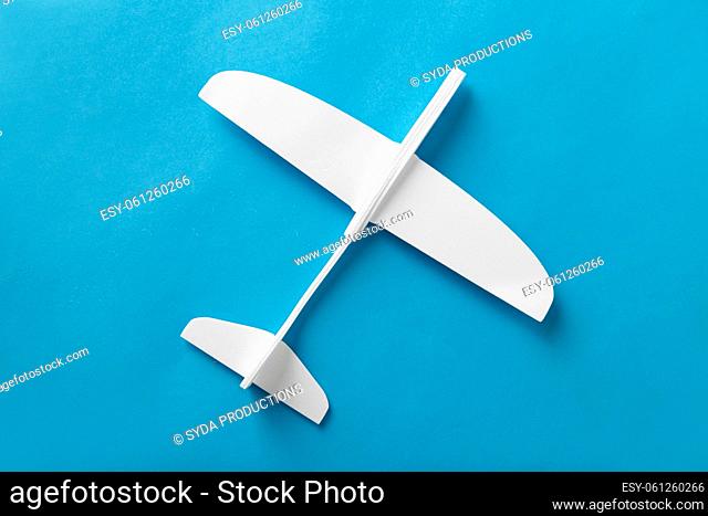 white toy plane model on blue background