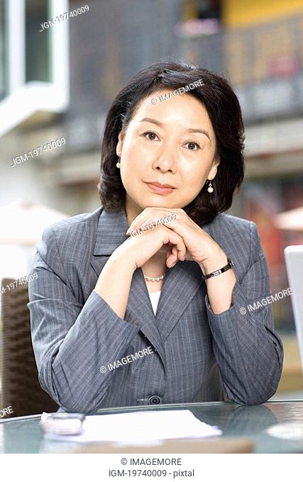 Businesswoman leaning on coffee table