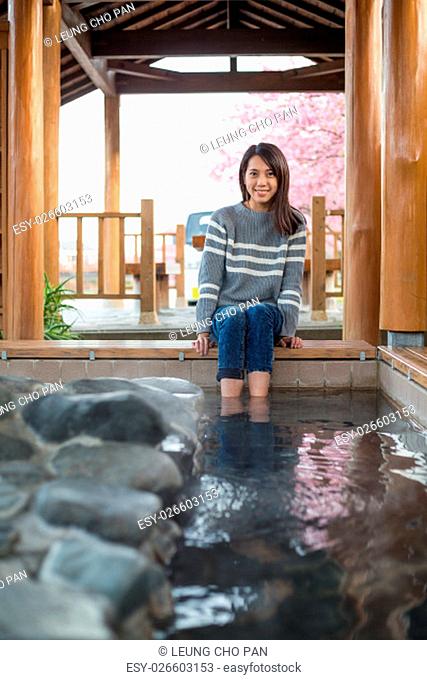 Woman relaxing on foot onsen