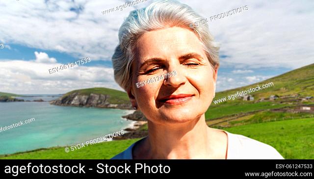 portrait of senior woman enjoying sun on beach