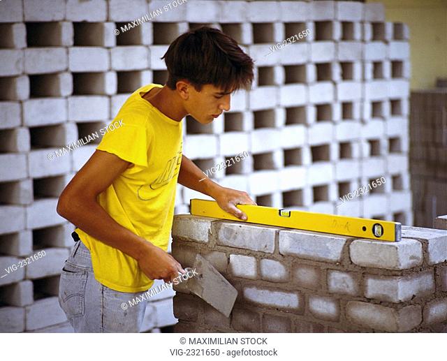 Apprentice bricklayer at work, - 01/01/2010