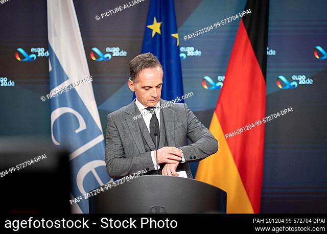 04 December 2020, Berlin: Heiko Maas (SPD), Foreign Minister, looks at the clock at the beginning of the press conference on the conclusion of the Council of...