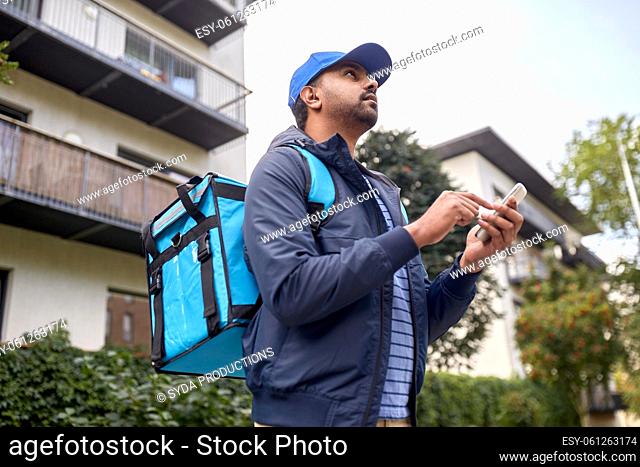 indian delivery man with bag and phone