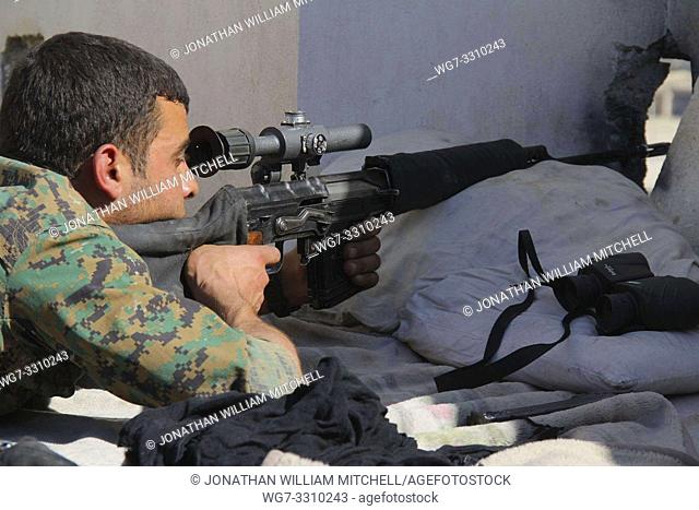 SYRIA / IRAQ -- circa 2016 -- Kurdish YPG sniper on the frontline somewhere in northern Syria or Iraq circa 2016 -- Picture by Atlas Photo Archive