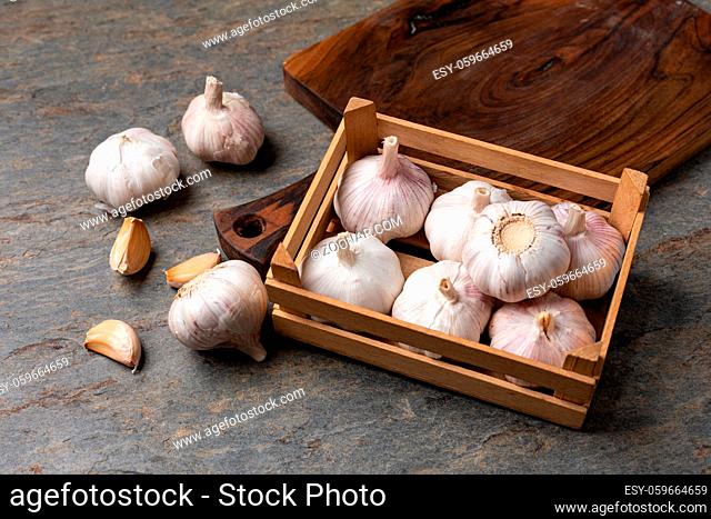 Garlic Cloves and Bulb in vintage wooden table