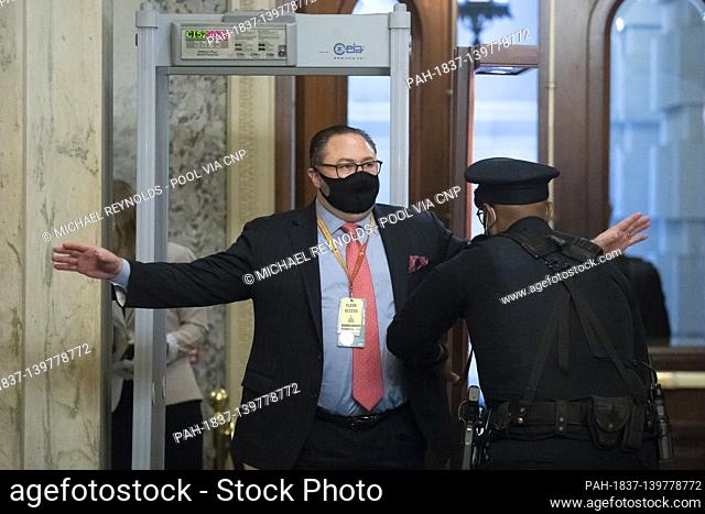 Jason Miller, advisor to former US President Donald Trump, is wanded by Capitol police upon arrival on the third day of the second impeachment trial of Trump in...
