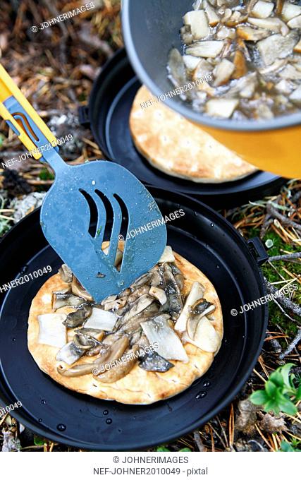 Pancakes with mushrooms prepared at camping