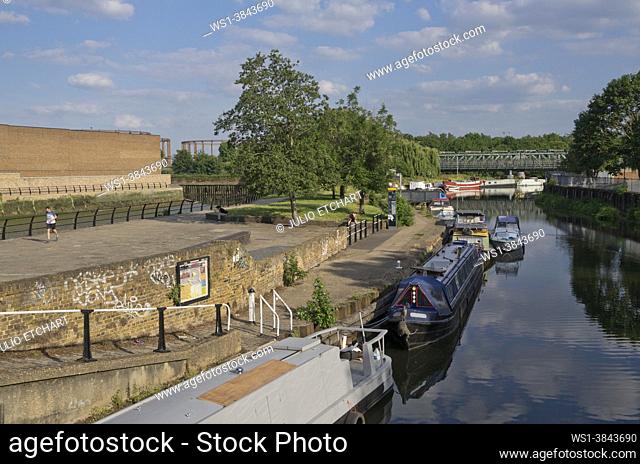 Barges and narrow boats by Lee river canal near Three Mills Film Studio in Bow, east London, England, UK