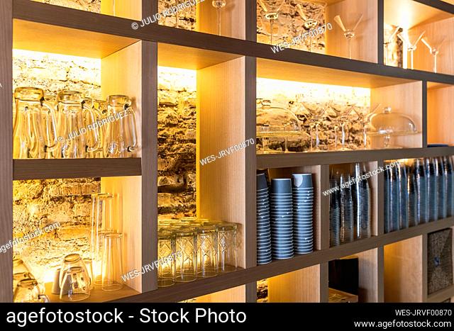 Glasses arranged on shelf in bar