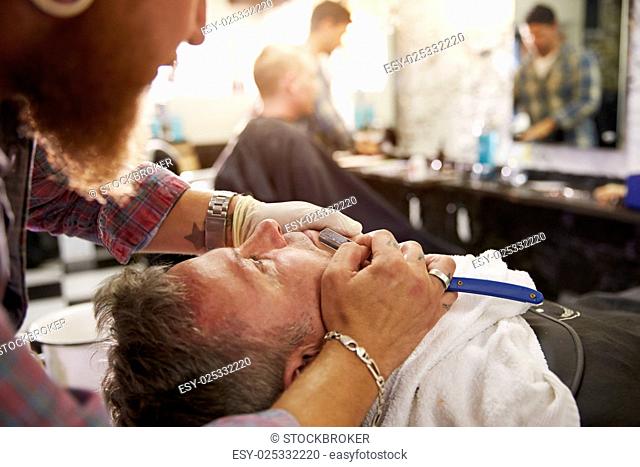 Barber Shaving Client With Cut Throat Razor