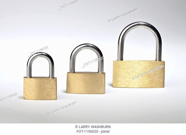 Three different sized padlocks in a row