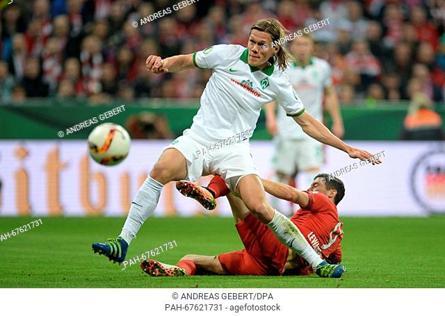 Munich's Robert Lewandowski (bottom) in action against Bremen's Jannik Vestergaard during the German DFB Cup semi final soccer match between Bayern Munich and...