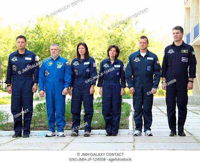The prime and backup crews for the launch of the Soyuz TMA-19 spacecraft to the International Space Station participate in the traditional flag-raising ceremony...