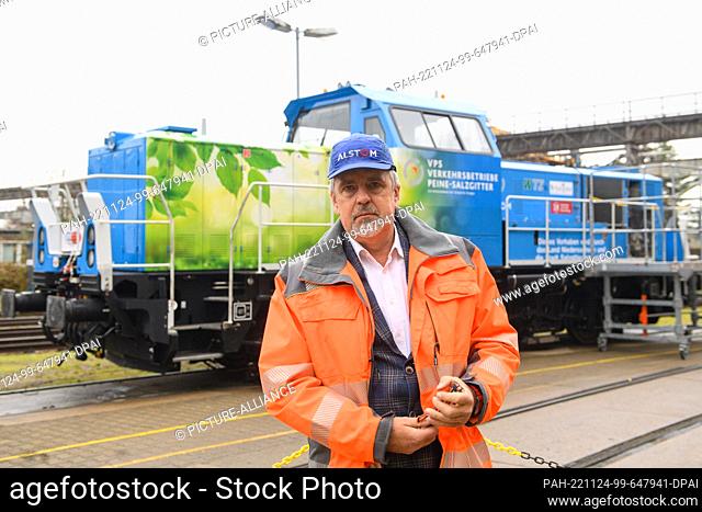 24 November 2022, Saxony-Anhalt, Stendal: Jörg Neubauer, Alstom's plant manager at the Stendal site, stands in front of a hydrogen-powered shunting locomotive