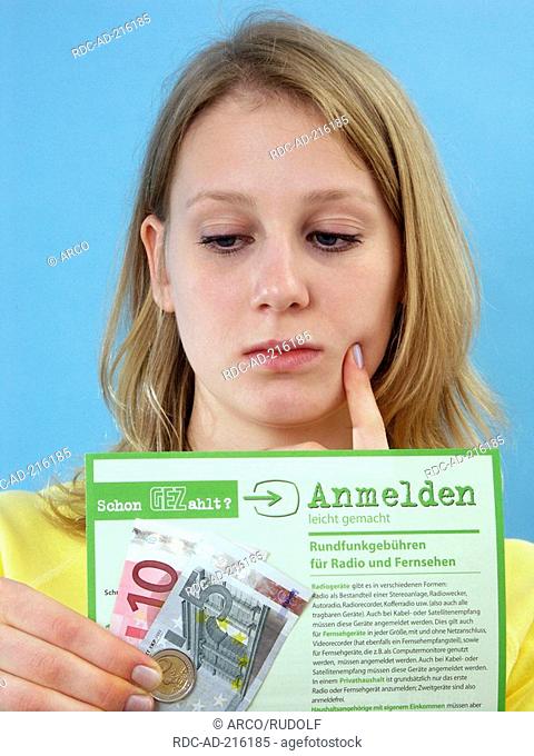 Girl with TV licence form and euro notes, registration, GEZ, fee collection center of public-law broadcasting institutions in the Federal Republic of Germany