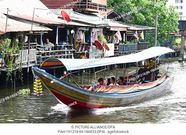 14 October 2019, Thailand, Bangkok: A longtail boat with tourists travels on a water channel, also called Klong. Photo: Sebastian Kahnert/dpa-Zentralbild