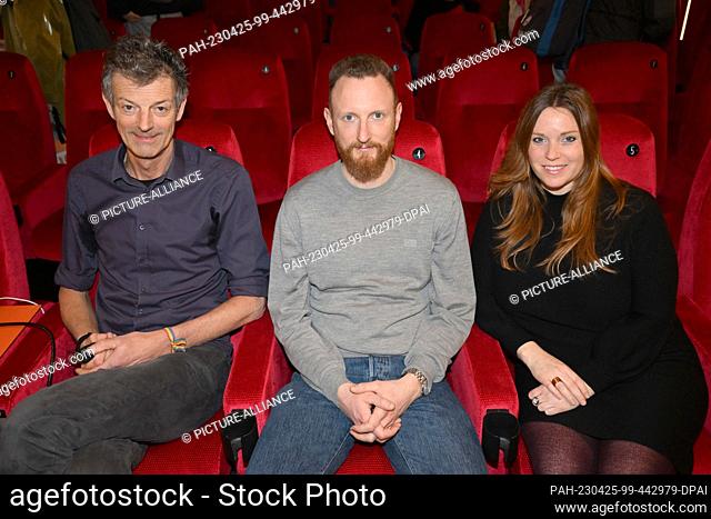 25 April 2023, Bavaria, Munich: Daniel Sponsel (l) and Adele Kohout (r) (both festival directors) and filmmaker Julian Vogel sit in the City Kino after the DOK