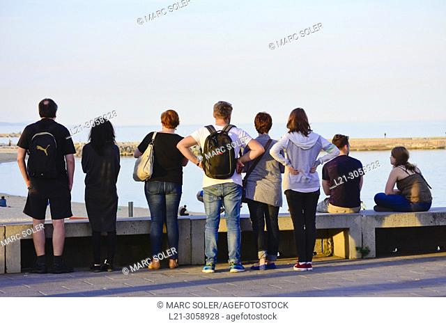 Rear view of people watching the sea. Barcelona, Catalonia, Spain